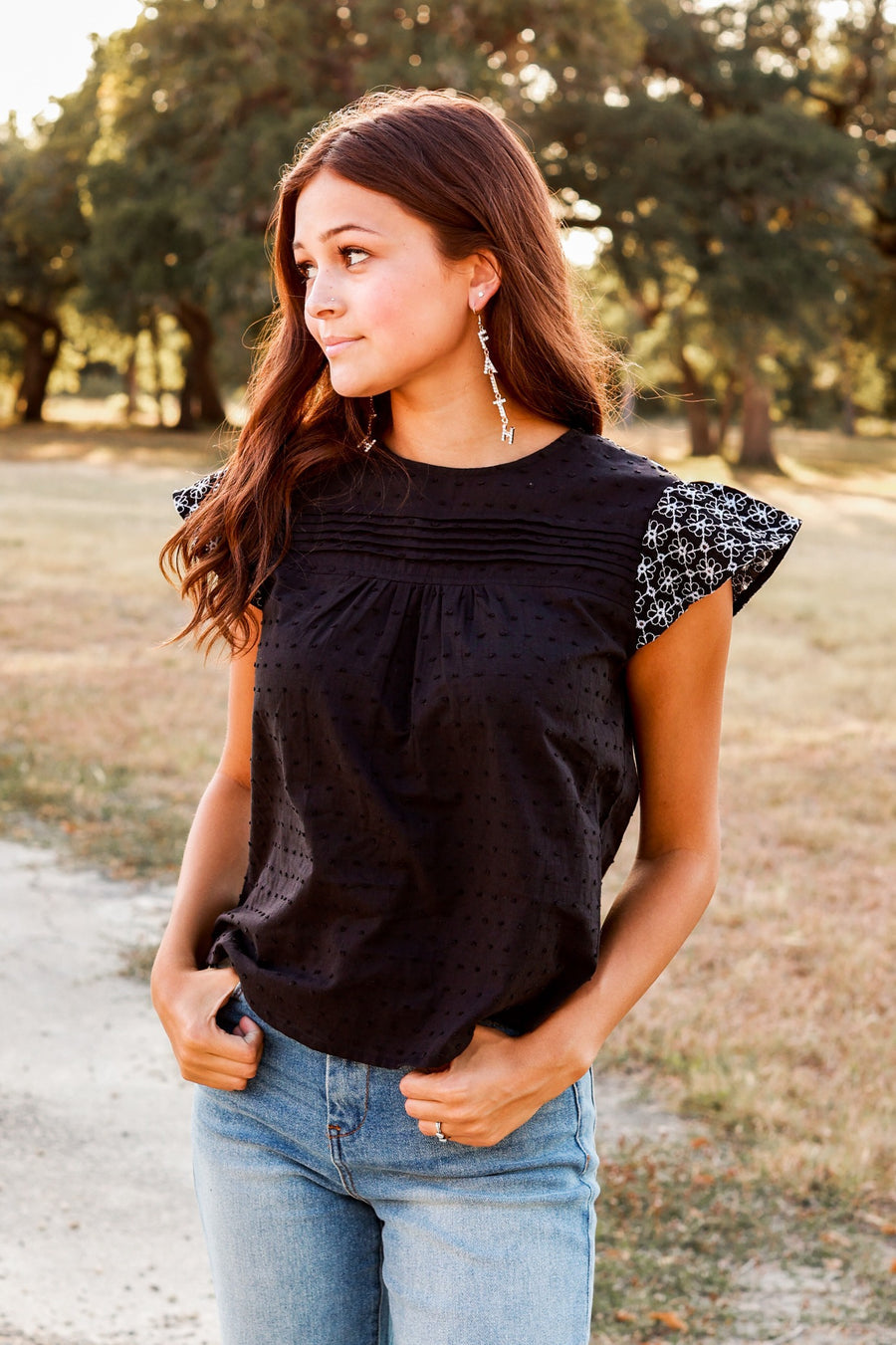 BLACK TOP WITH FLORAL EYELET FLUTTER SLEEVES